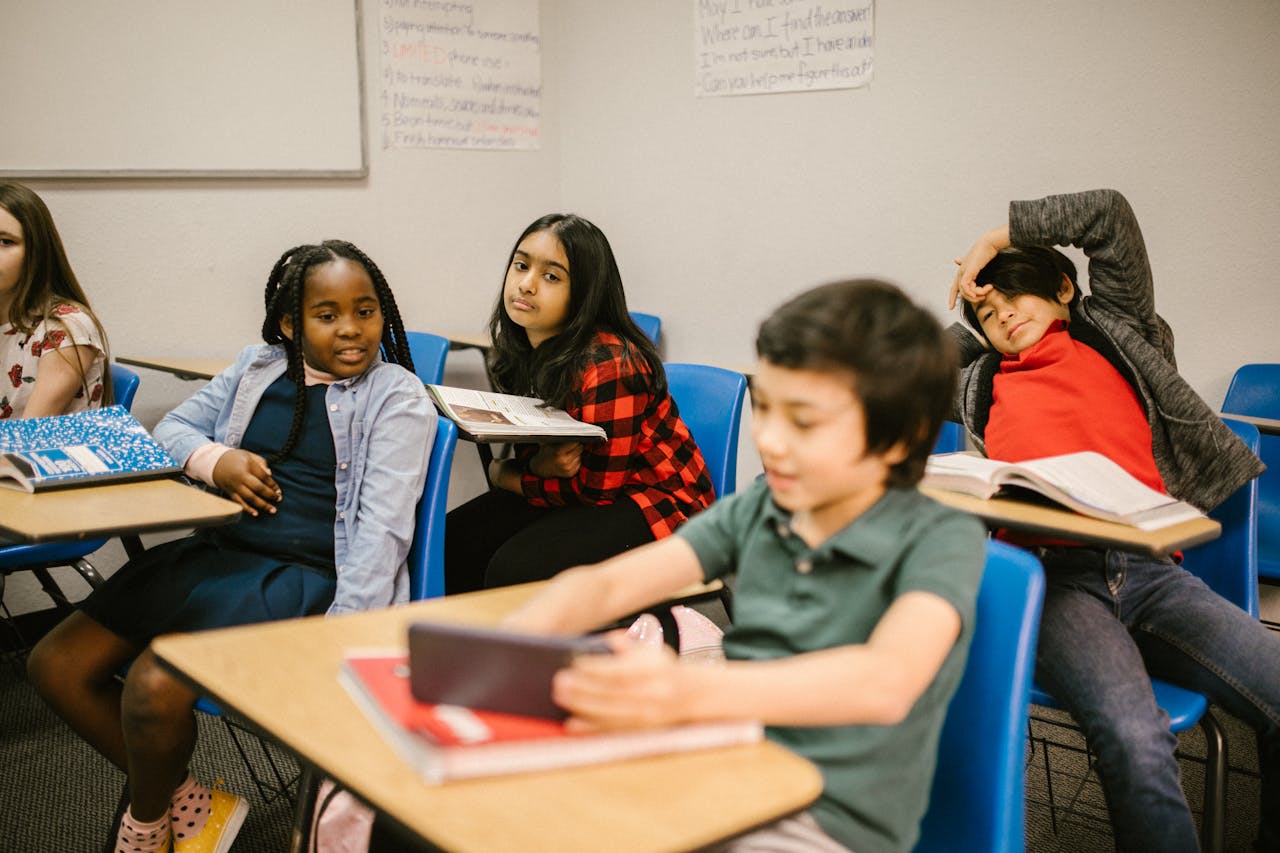 Kids interacting in a classroom, showcasing diversity and learning environment.